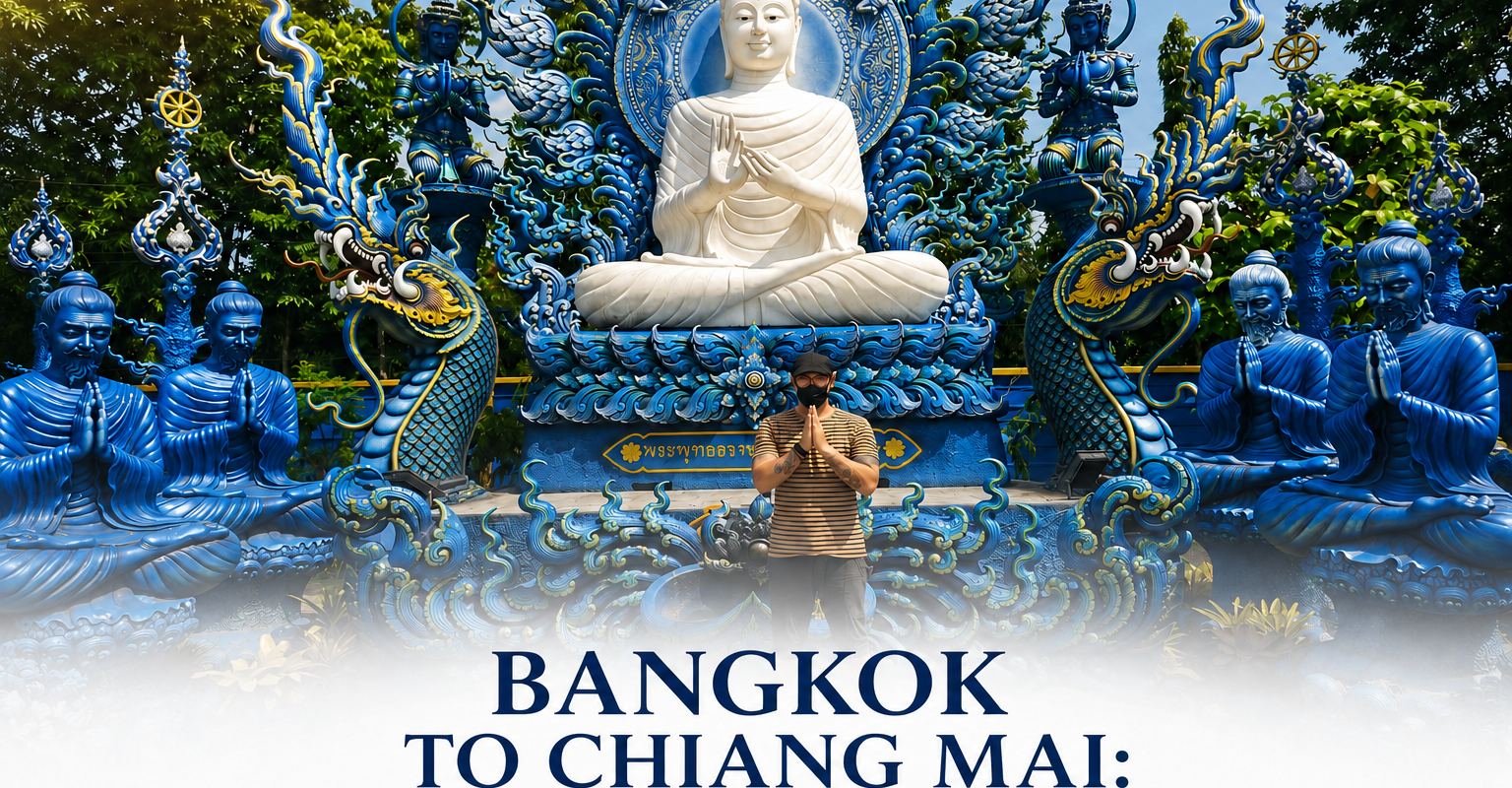 A man performs a traditional Thai Wai greeting in front of a majestic, intricate blue temple featuring a large white seated Buddha, representing a highlight of a private Bangkok to Chiang Mai 7-day tour.